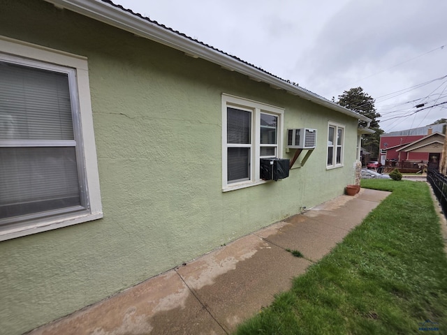 142 W Summit, Lead, SD 57754 - view of home's exterior featuring stucco siding, fence, and a wall unit AC