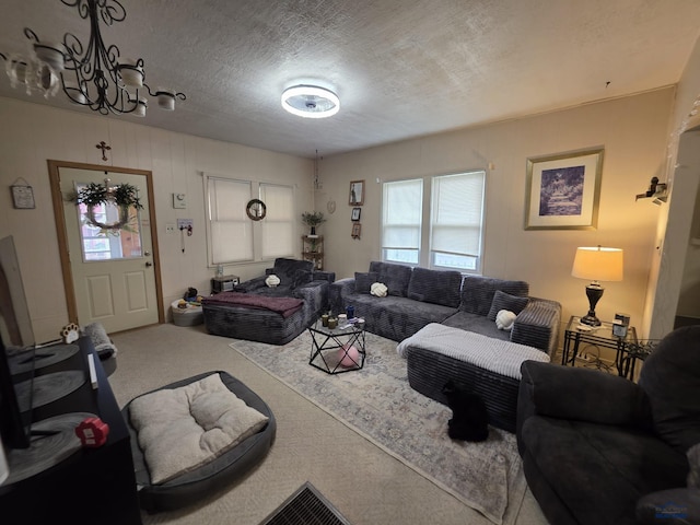 142 W Summit, Lead, SD 57754 - carpeted living room with plenty of natural light, a chandelier, and a textured ceiling