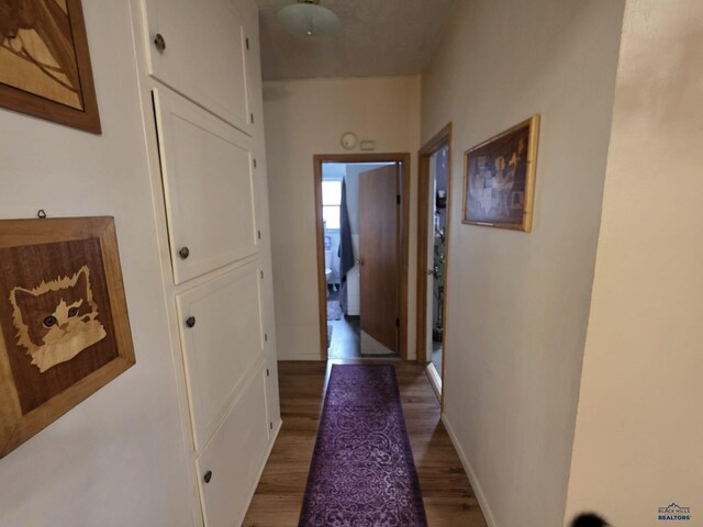 142 W Summit, Lead, SD 57754 - hall with light wood-type flooring and baseboards