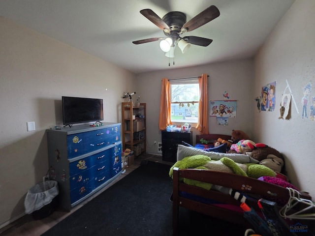 bedroom with a ceiling fan and dark carpet