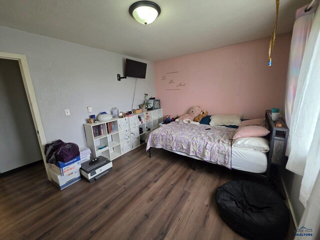 bedroom with dark wood-type flooring