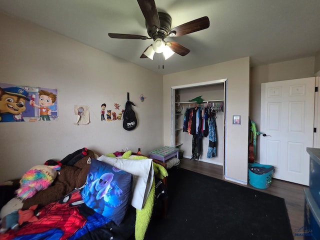 bedroom featuring wood finished floors, a closet, and ceiling fan