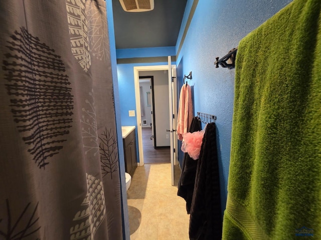 corridor featuring a textured wall