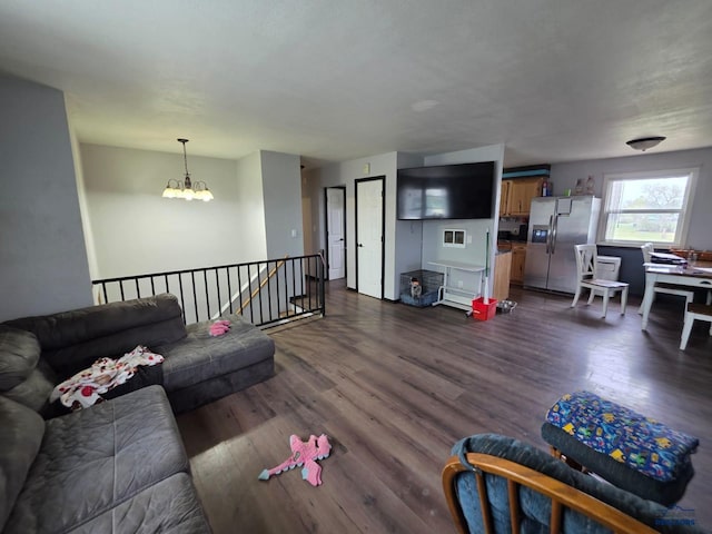living area featuring a chandelier and dark wood-style flooring