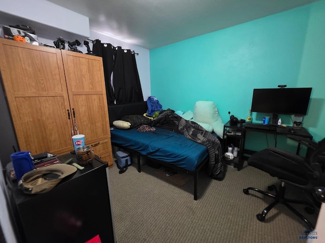 carpeted bedroom featuring a desk