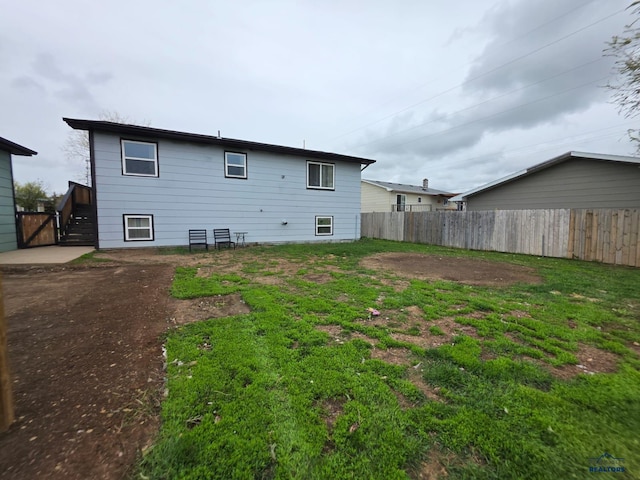 rear view of property with fence