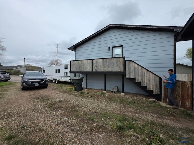 view of side of property featuring stairs