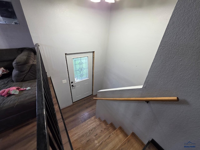 staircase featuring wood finished floors
