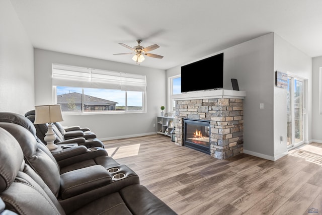 506 Solomon Ct, Rapid City, SD 57703 - living area with a ceiling fan, wood finished floors, plenty of natural light, and a fireplace