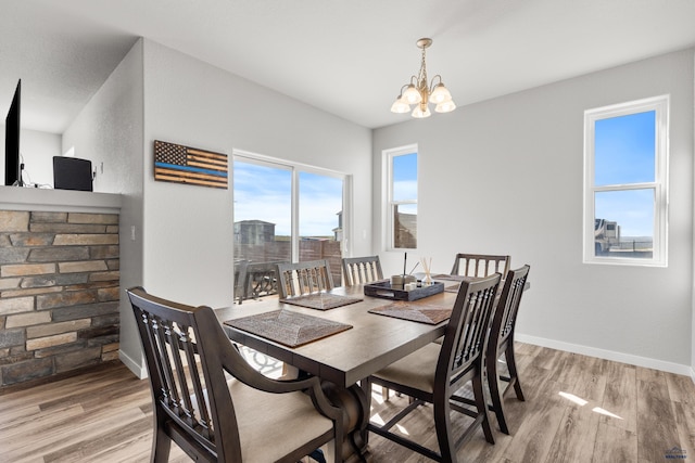 506 Solomon Ct, Rapid City, SD 57703 - dining room with a chandelier, light wood-style flooring, and baseboards