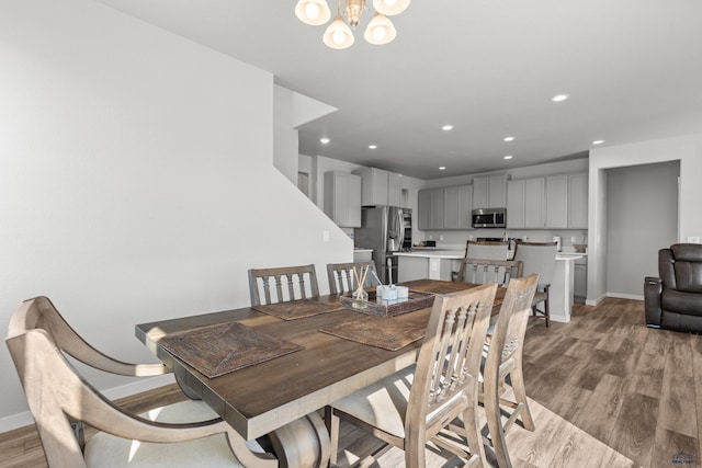 506 Solomon Ct, Rapid City, SD 57703 - dining room featuring baseboards, light wood-style floors, recessed lighting, and a chandelier