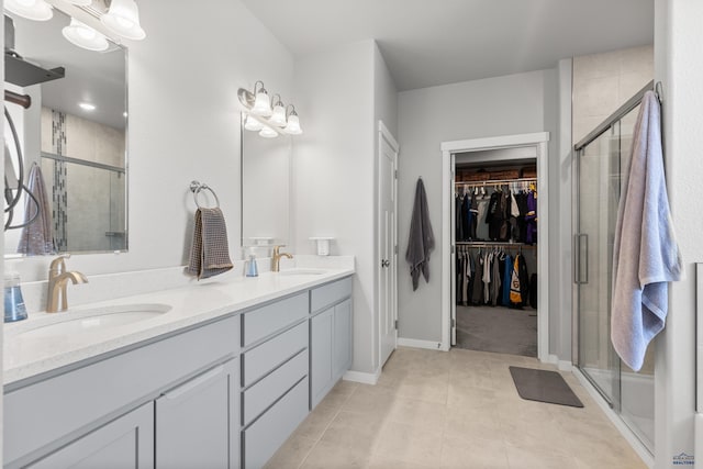 506 Solomon Ct, Rapid City, SD 57703 - bathroom with a shower stall, a spacious closet, double vanity, and tile patterned floors