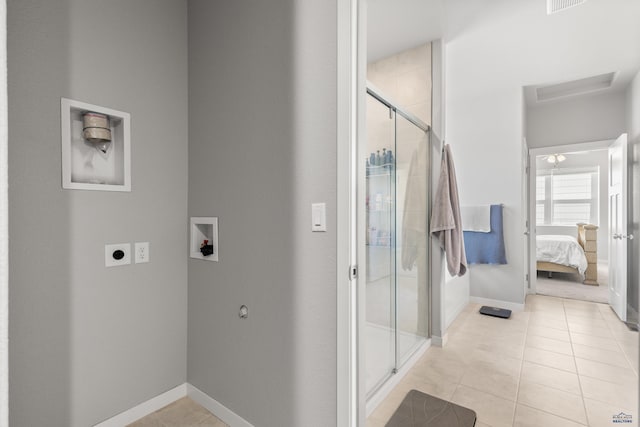 506 Solomon Ct, Rapid City, SD 57703 - full bathroom with connected bathroom, a shower stall, tile patterned floors, and baseboards