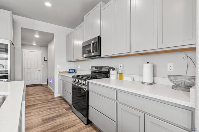 506 Solomon Ct, Rapid City, SD 57703 - kitchen featuring stainless steel appliances, light wood-style flooring, recessed lighting, and baseboards