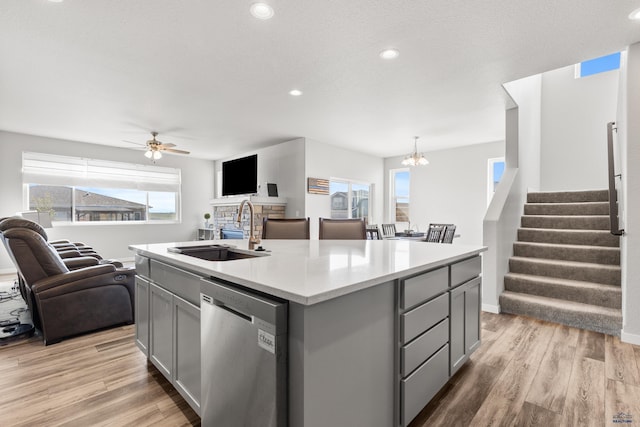 506 Solomon Ct, Rapid City, SD 57703 - kitchen featuring dishwasher, a sink, gray cabinetry, open floor plan, and light countertops