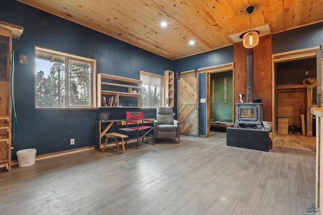 24427 Thovson Rd, Keystone, SD 57751 - sitting room featuring a wood stove, a barn door, wooden ceiling, recessed lighting, and wood finished floors