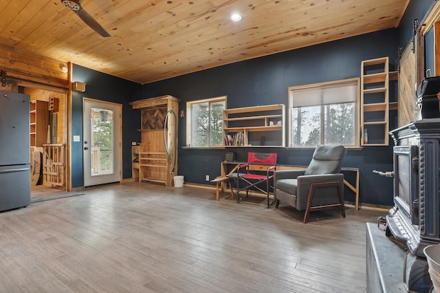 24427 Thovson Rd, Keystone, SD 57751 - sitting room featuring wooden ceiling, a barn door, healthy amount of natural light, wood finished floors, and recessed lighting