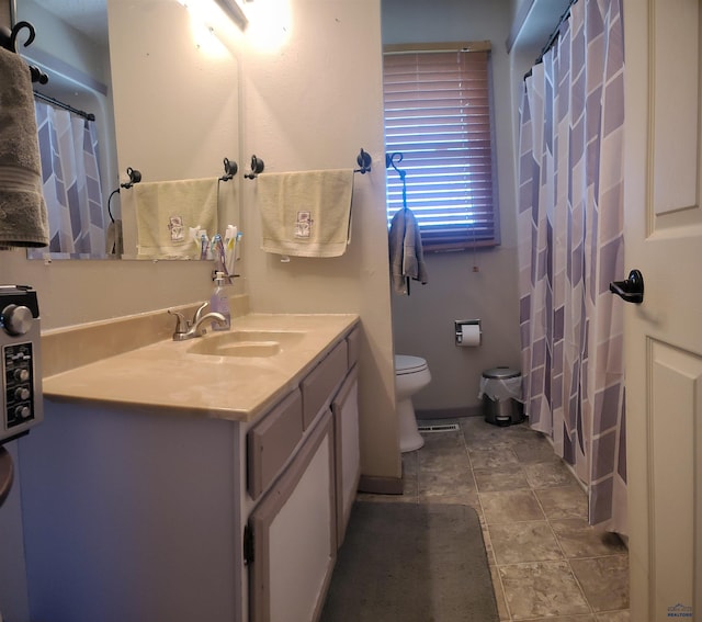 4218 Sweetbriar, Rapid City, SD 57703 - bathroom with toilet, vanity, and a shower with shower curtain