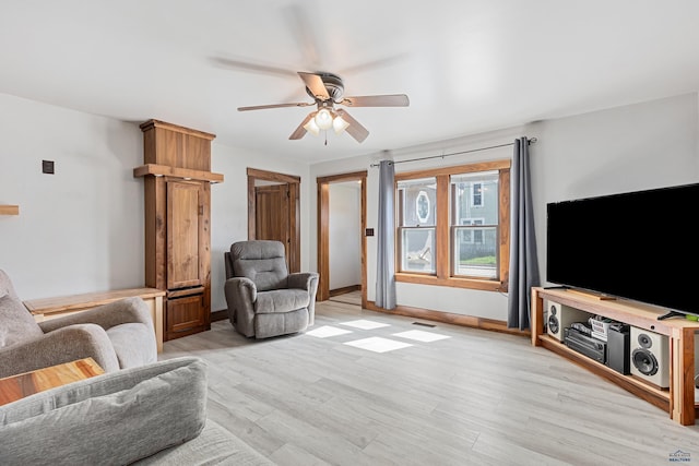 819 Sly St, Sturgis, SD 57785 - living area featuring a ceiling fan, light wood-style flooring, and baseboards