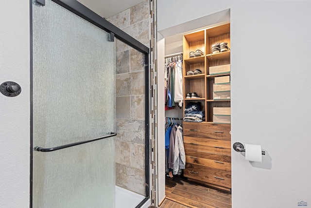 819 Sly St, Sturgis, SD 57785 - bathroom with a shower stall, wood finished floors, and a walk in closet