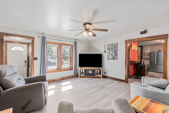 819 Sly St, Sturgis, SD 57785 - living area with ceiling fan, baseboards, and light wood-style flooring