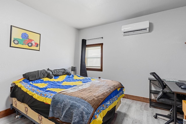 819 Sly St, Sturgis, SD 57785 - bedroom with a wall mounted AC, wood finished floors, baseboards, and a desk