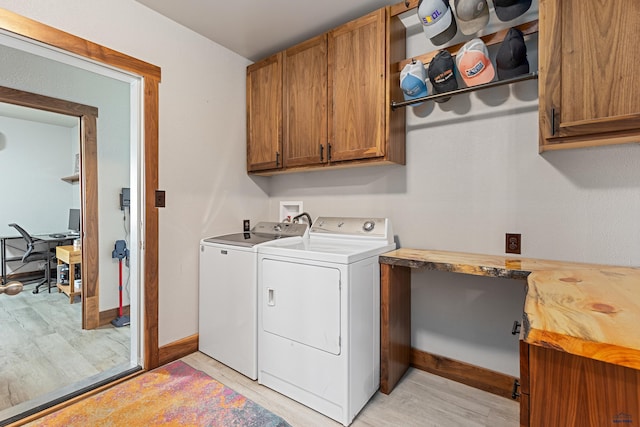 819 Sly St, Sturgis, SD 57785 - laundry room featuring cabinet space, washing machine and clothes dryer, light wood finished floors, and an office area