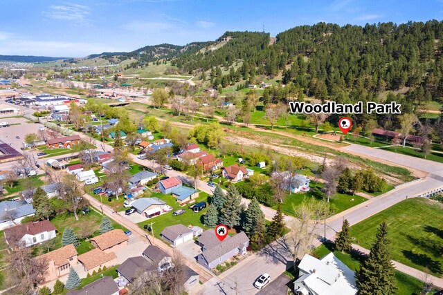 819 Sly St, Sturgis, SD 57785 - aerial view of property's location featuring a mountain backdrop and nearby suburban area