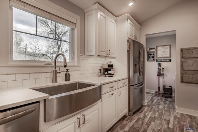 1316 Clark, Rapid City, SD 57701 - kitchen with a sink, stainless steel appliances, decorative backsplash, baseboards, and white cabinetry