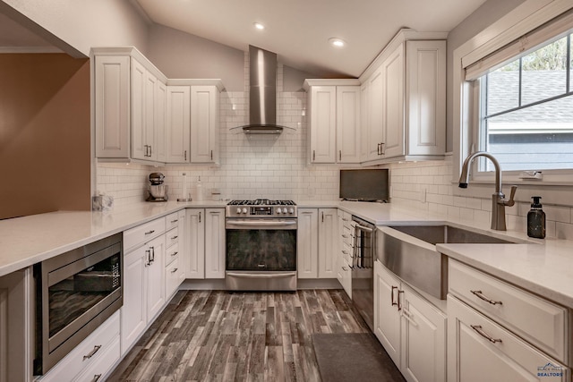 1316 Clark, Rapid City, SD 57701 - kitchen with stainless steel appliances, wall chimney range hood, a sink, recessed lighting, and dark wood-style floors