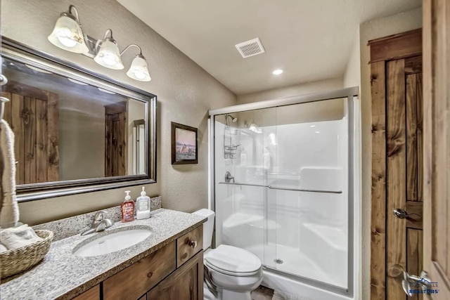 21172 Last Chance Trl, Lead, SD 57754 - bathroom featuring a textured wall, a shower stall, toilet, and vanity