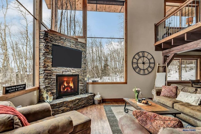 21172 Last Chance Trl, Lead, SD 57754 - living area with a fireplace, wood finished floors, baseboards, and plenty of natural light