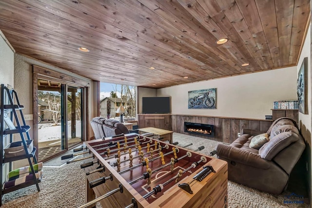 21172 Last Chance Trl, Lead, SD 57754 - rec room with wood ceiling, wainscoting, a tiled fireplace, recessed lighting, and carpet floors