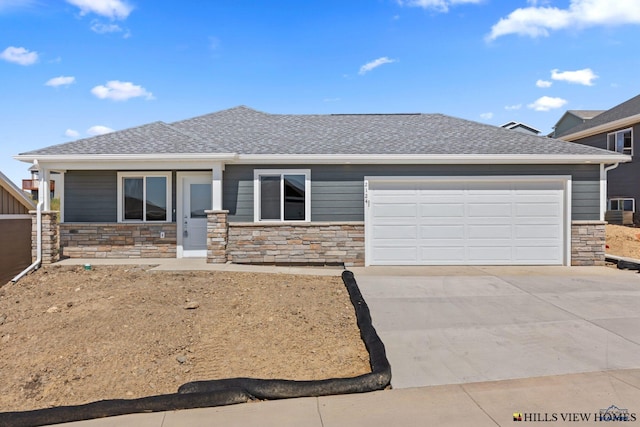 436 Henry Potter Rd, Box Elder, SD 57719 - view of front of house with stone siding, concrete driveway, and a garage