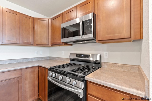 436 Henry Potter Rd, Box Elder, SD 57719 - kitchen with stainless steel appliances, light countertops, and brown cabinets