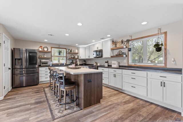 202 S B Ave, New Underwood, SD 57761 - kitchen with open shelves, appliances with stainless steel finishes, a kitchen island, white cabinets, and recessed lighting