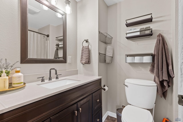 202 S B Ave, New Underwood, SD 57761 - bathroom featuring toilet, vanity, and baseboards