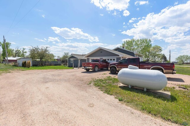 202 S B Ave, New Underwood, SD 57761 - view of front facade featuring dirt driveway and a garage