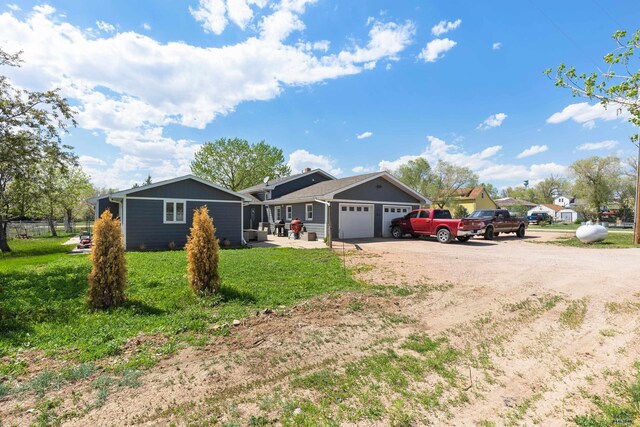 202 S B Ave, New Underwood, SD 57761 - ranch-style house featuring dirt driveway, a garage, and a front yard