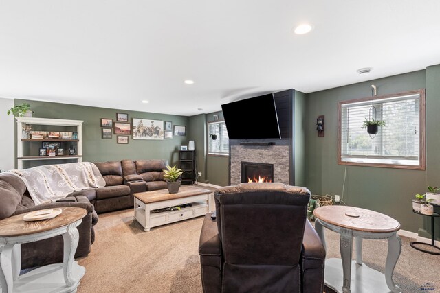 202 S B Ave, New Underwood, SD 57761 - living area with light colored carpet, a stone fireplace, recessed lighting, and baseboards