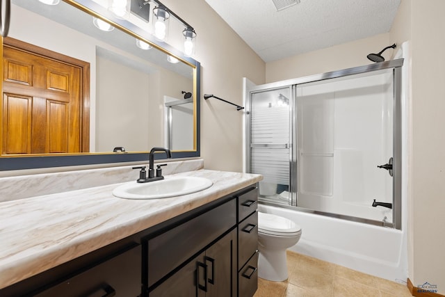 12087 Kaubisch Ranch Rd, Hill City, SD 57745 - full bathroom with vanity, a textured ceiling, toilet, enclosed tub / shower combo, and tile patterned flooring