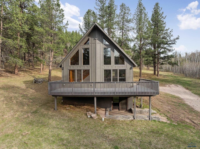 12087 Kaubisch Ranch Rd, Hill City, SD 57745 - rear view of property featuring a wooden deck and a lawn