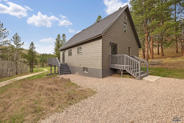 12087 Kaubisch Ranch Rd, Hill City, SD 57745 - view of side of property featuring roof with shingles, stairway, and a deck