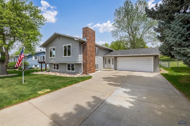 3204 Flint Dr, Rapid City, SD 57702 - tri-level home with a garage, concrete driveway, and a chimney