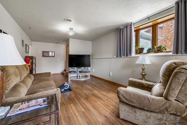 3204 Flint Dr, Rapid City, SD 57702 - living area featuring wood finished floors, a textured ceiling, and baseboards
