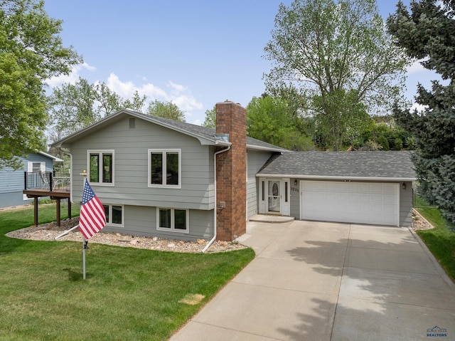 3204 Flint Dr, Rapid City, SD 57702 - tri-level home featuring a garage, a chimney, concrete driveway, a front yard, and roof with shingles