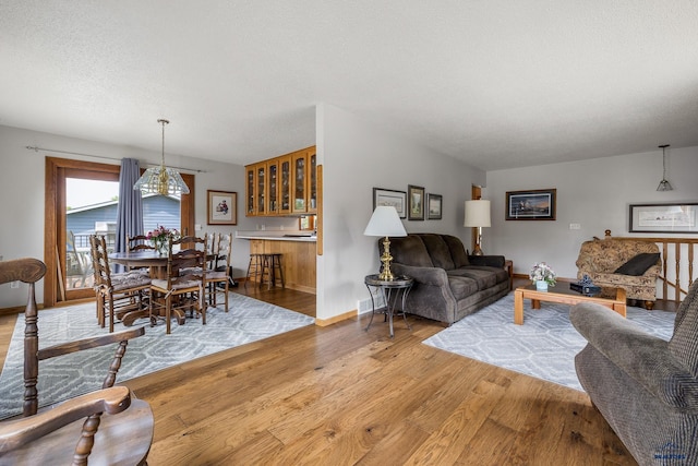 3204 Flint Dr, Rapid City, SD 57702 - living room featuring wood finished floors, baseboards, and bar area
