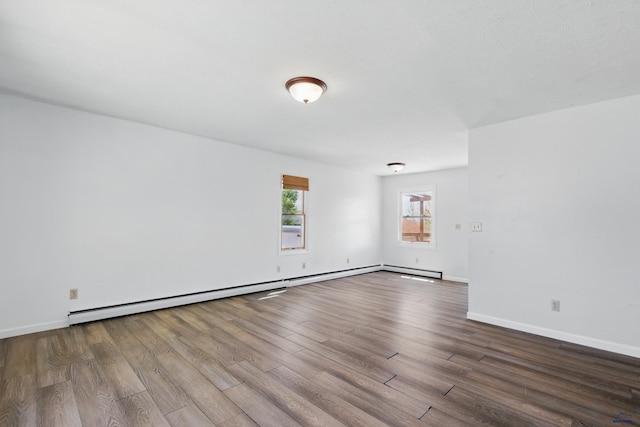 5753 Pluto, Rapid City, SD 57703 - empty room with wood finished floors, baseboards, and baseboard heating