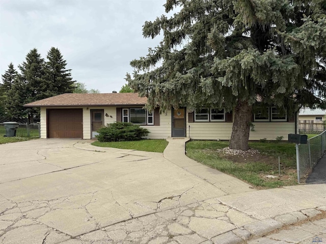view of front of property with a garage, driveway, and fence