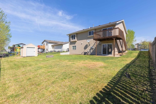 573 Plover Dr, Box Elder, SD 57719 - back of house featuring stairs, a deck, a storage shed, and an outbuilding